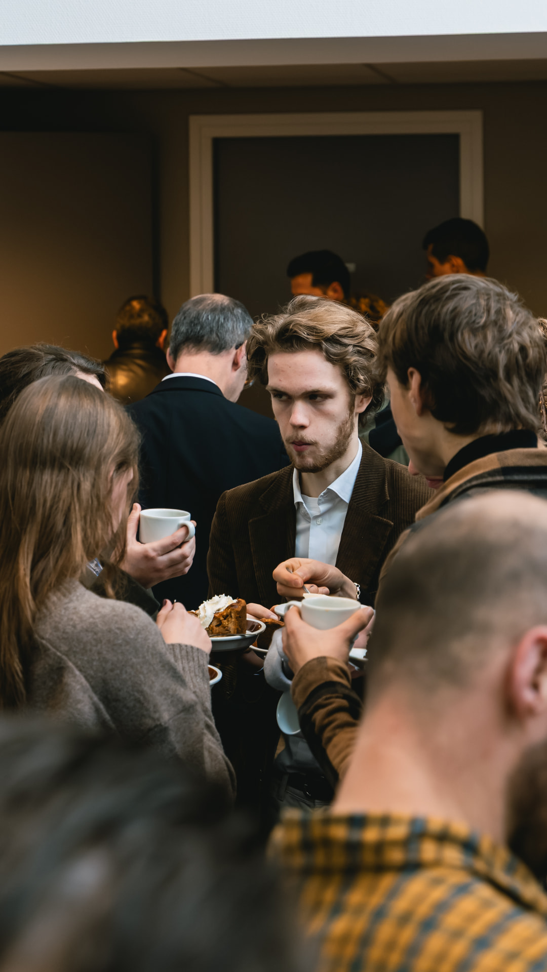 Gemeenteleden in gesprek met koffie en gebak na afloop van een dienst